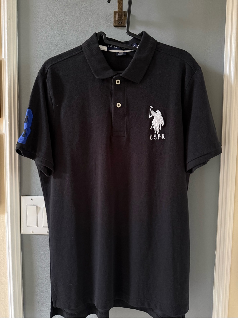 U.S. Polo Assn. Black Polo with White Logo and Blue Sleeve Number